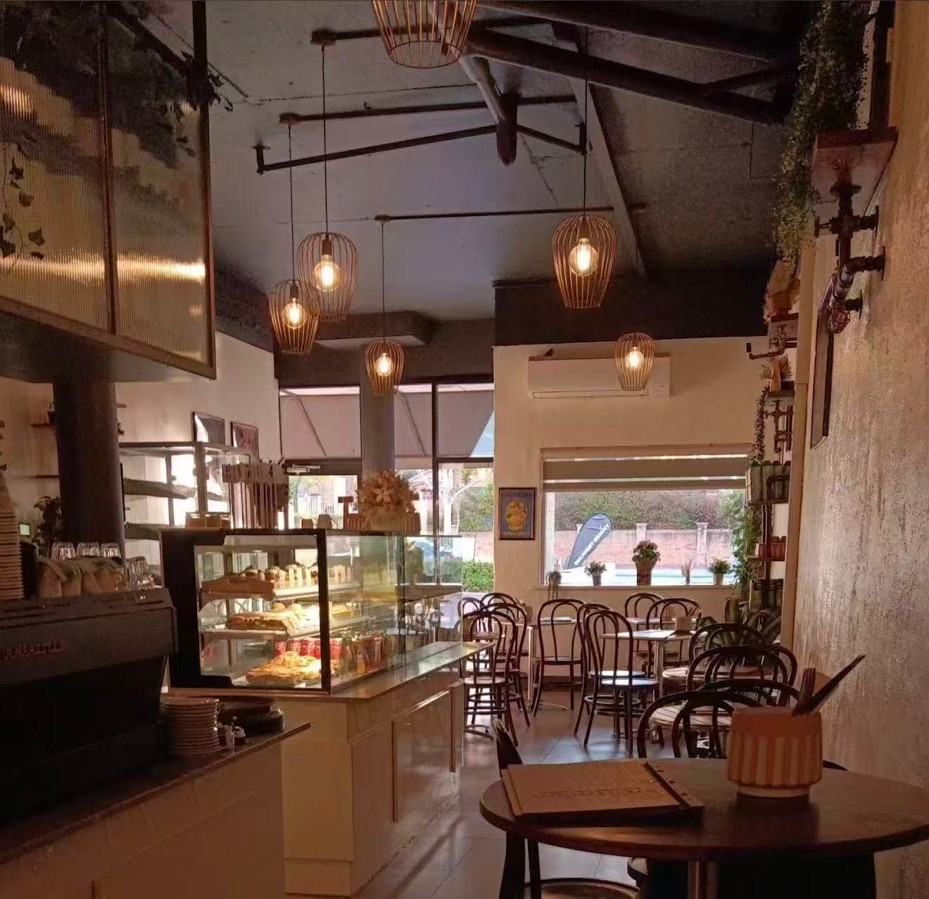 Inside 7nnine — pendant lights and pastry case
